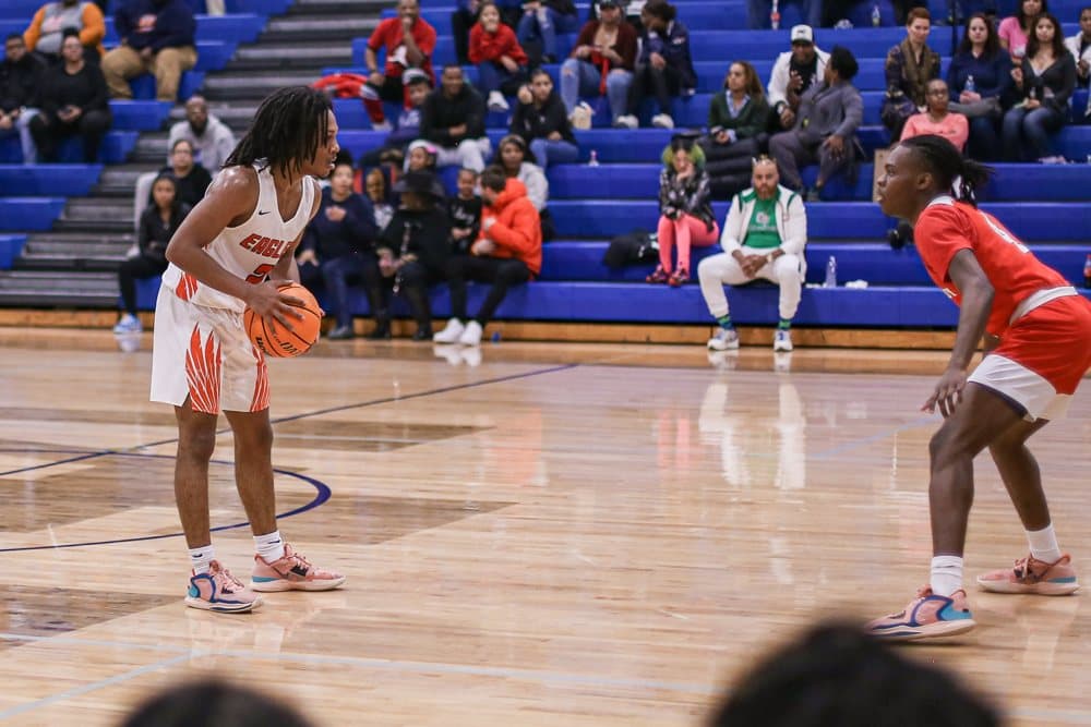 Sizing up the defender at the top of the key