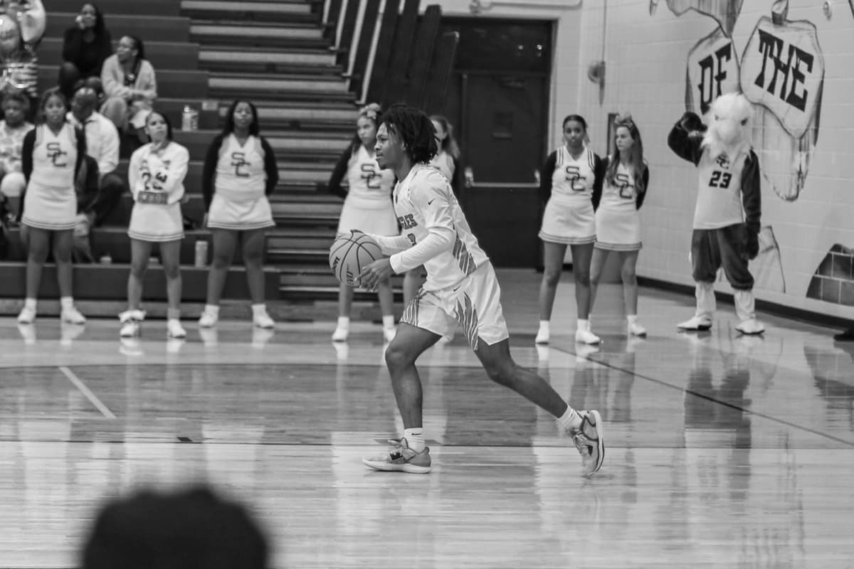Bringing the ball up past the cheer line and the mascot